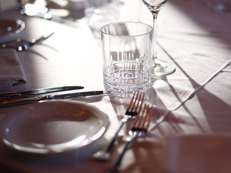 A formal place setting with glassware and silver cutlery