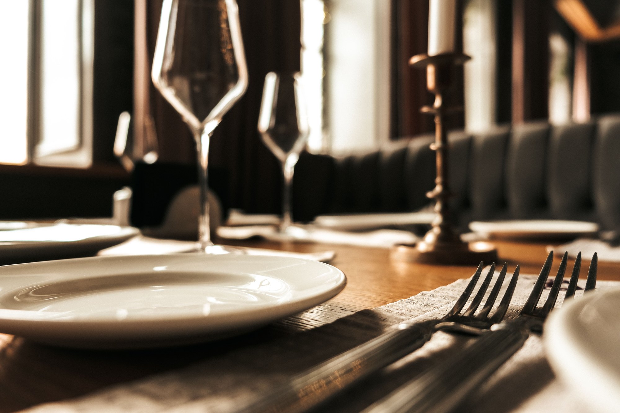 A formal table laid with glassware, silver and candlelight