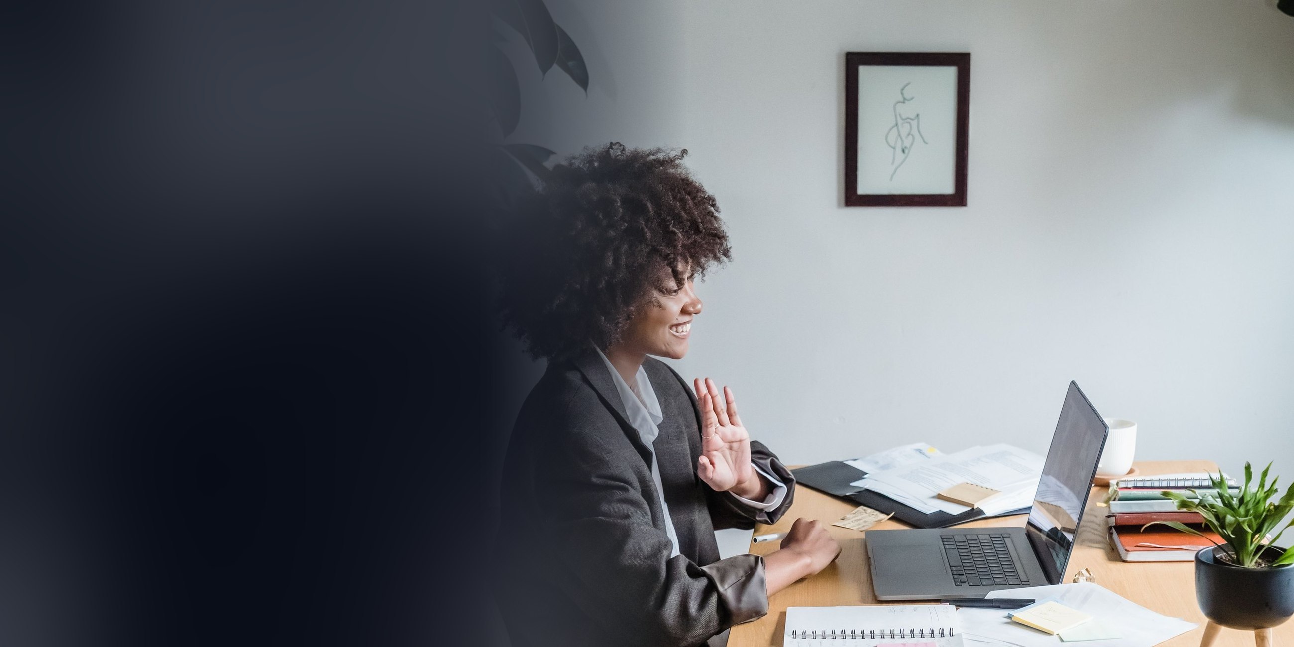 A woman at her desk in an online coaching session on her laptop