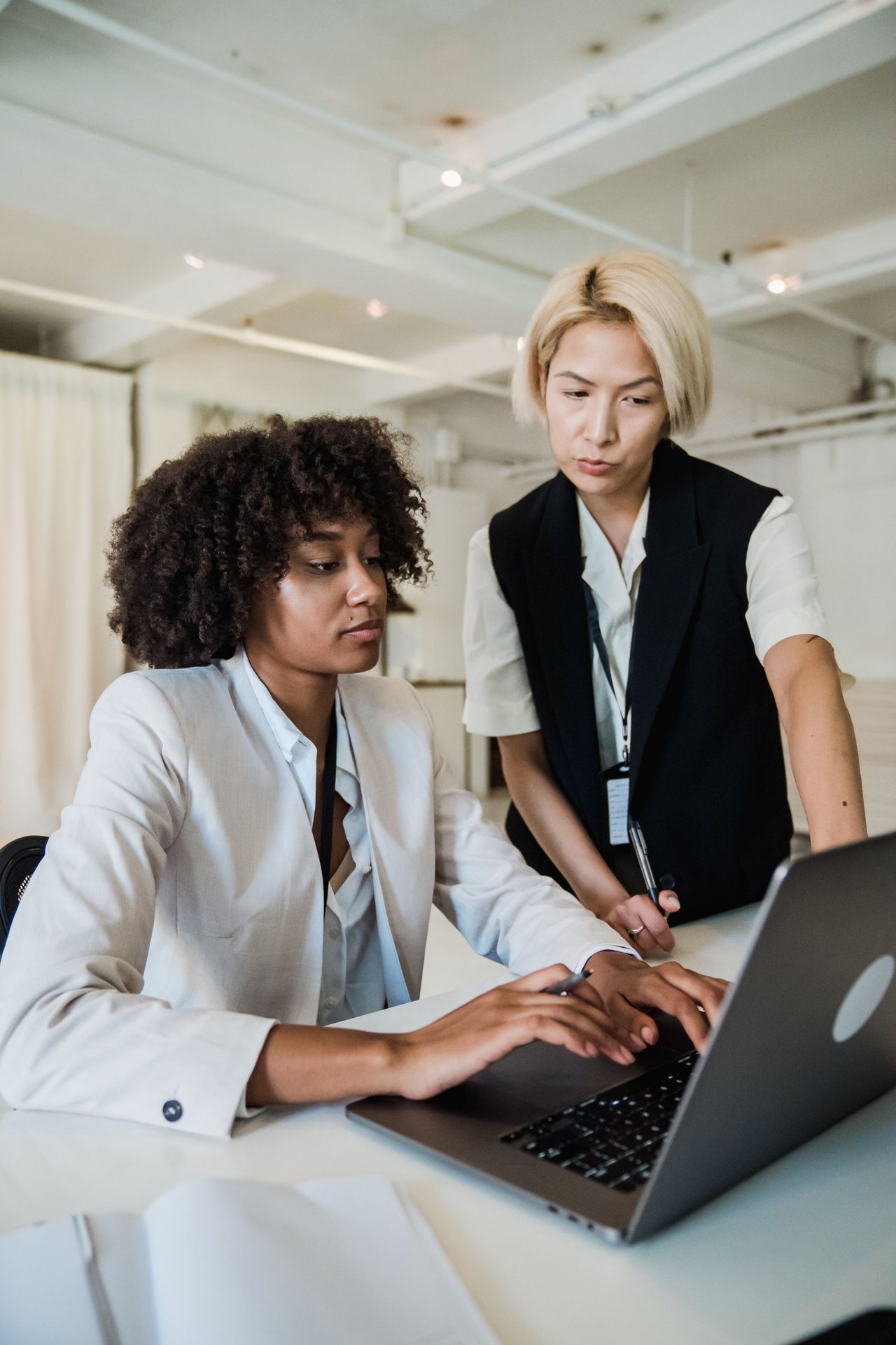 A mentor guiding a professional through practical development work